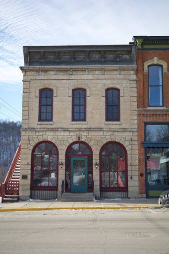 A vertical shot of a beautiful corner store under the blue sky