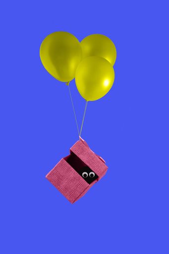 An illustration of a pink gift box flies with yellow balloons, Valentine's Day