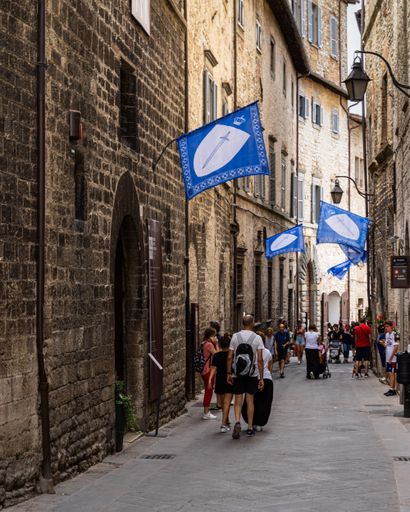 A vertical shot of a medieval pedestrian street in Gubbio historic center: Gubbio, Umbria, Aug. 2021