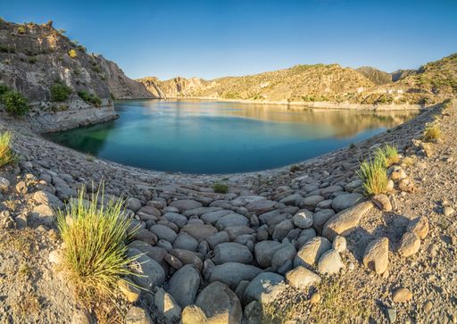 A landscape view of a lake surrounded by cliffs