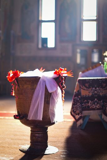 A vertical shot of the interior of the part of Romanian church in the sunlight