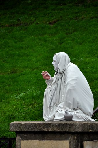 A vertical shot of a male performer covered with white sheet, Paris, France