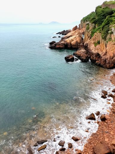A beautiful shot of a rocky beach under a blue sky on a sunny day