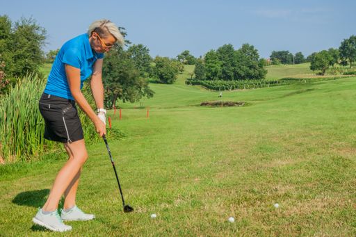 A female professional golfer about to hit a ball at the golf course of Zlati Gric in Slovenia