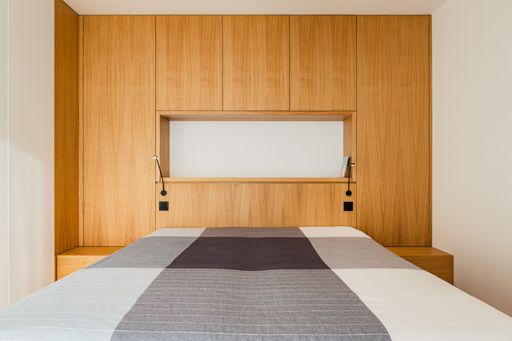 The modern bedroom design in brown, gray, and white colors.