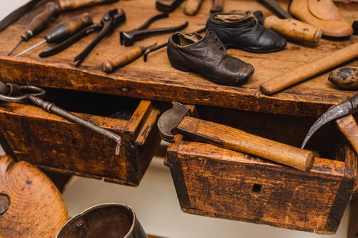A closeup shot of different tools of a cobbler workplace