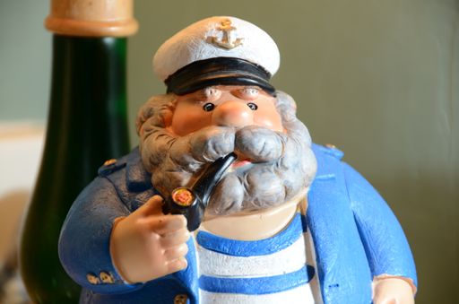 A closeup shot of the old captain figurine with a pipe