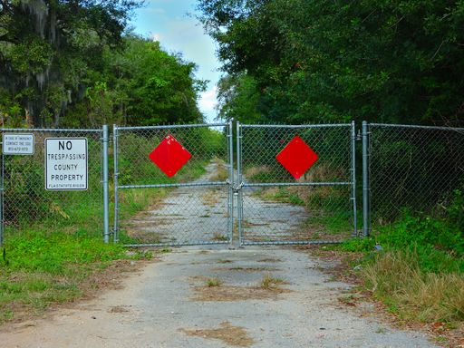 A closeup of a Scary looking closed off county street in Gibsonton, FL. Kracker Ave.