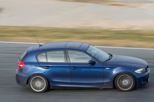A closeup of BMW 1 Series in blue color on a racing circuit