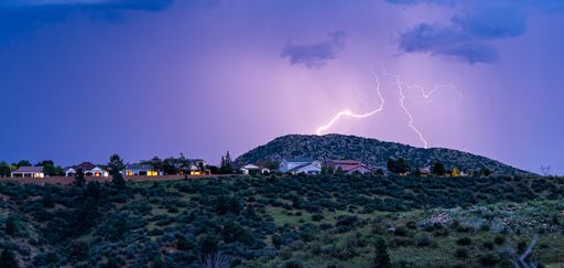 A beautiful view of lightning striking above houses in Prescott Valley, Arizona