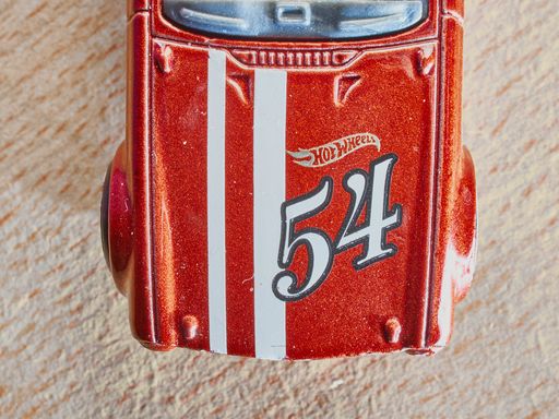 A top view macro shot of a little red hotwheels toy