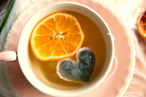 A shot from the top of a tea with oranges.
