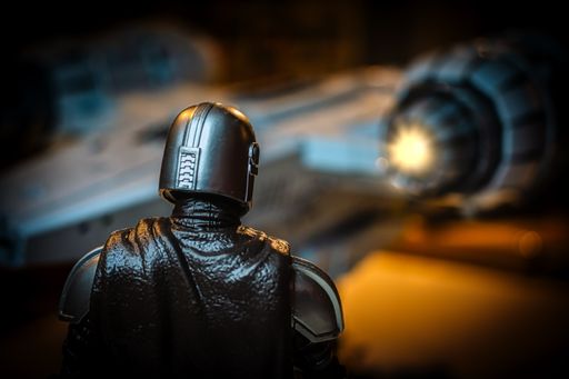 Symbol picture of The Mandalorian, the new Disney plus series in the background the starship Razor Crest