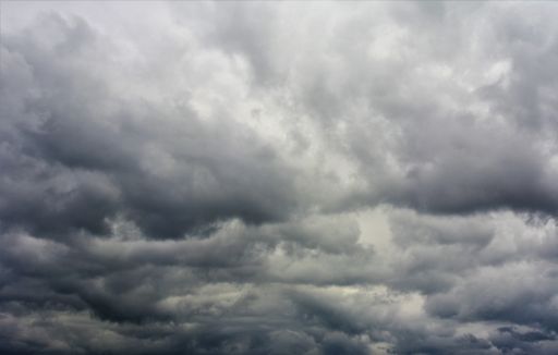 A low angle shot of the beautiful and fluffy rain clouds in the sky