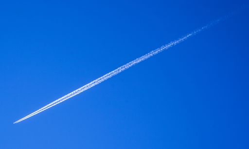 A low angle shot of a beautiful blue sky view with traces of plane