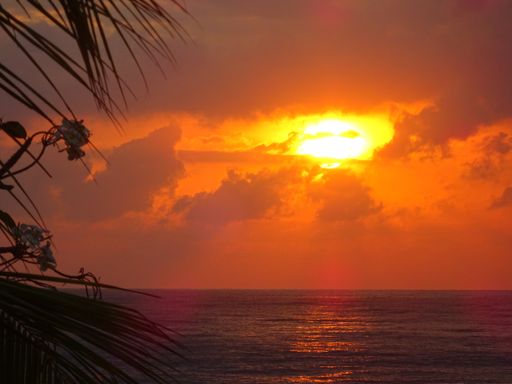 A beautiful view of a sea with orange sunset in Bali