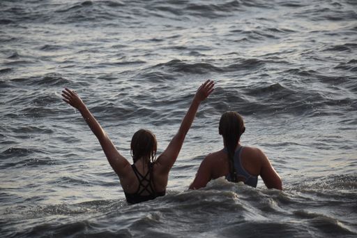 Two friends having fun and swimming in the sea