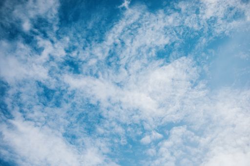A low angle shot of a blue cloudy sky on a sunny day - perfect for wallpapers