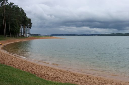 A shot of forest and beach with sea and cloudy sky in Brombachsee, Bavaria, Germany