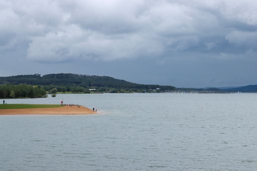 A shot of forest and beach with sea and cloudy sky in Brombachsee, Bavaria, Germany
