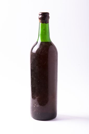 A closeup shot of a bottle of red wine on a white background
