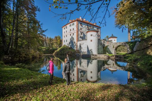 The tourists near the beautiful Sneznik castle in Sneznik, Slovenia