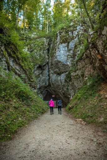 A vertical shot of a man and a woman near the Krizna cave in Slovenia