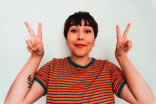 A happy woman showing peace sign with fingers