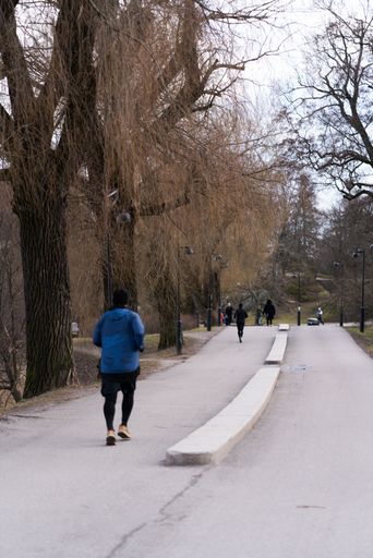 Runners in Helsinki, Finland. People exercising in a park in the Nordics