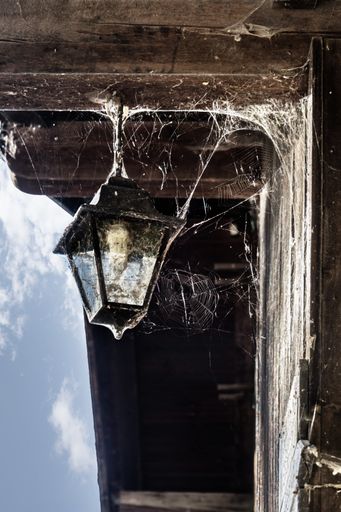 A closeup of a lamp on an abandoned building