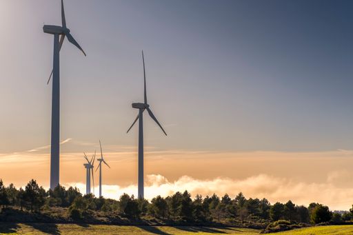 The view of wind turbines on sunset sky background in a rural area in Spain