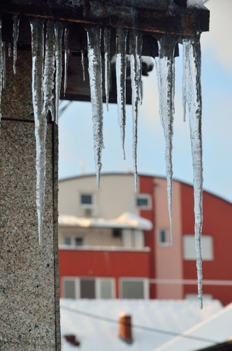 A selective of icicles hanging from a roof