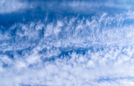 Beautiful and calming cirrus cloud formations in a deep blue summer sky.
