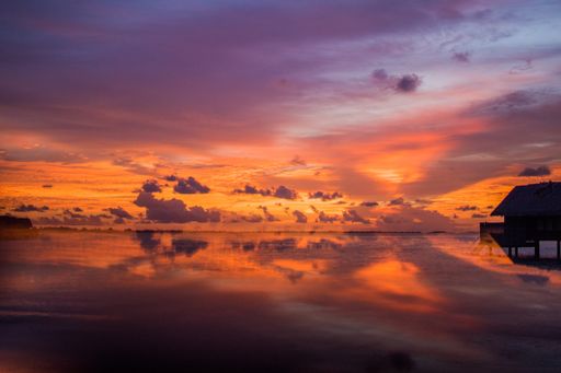 A beautiful coastal landscape with a colorful sunset sky reflected in the water