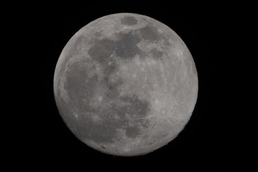 A zoomed view of the beautiful grey Moon with pits on the lunar surface