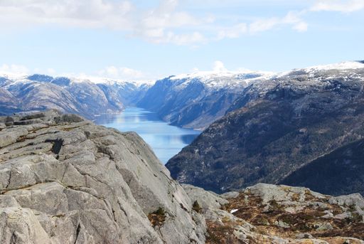The beautiful scenery of snowy and rocky mountains and hills with a small lake in between