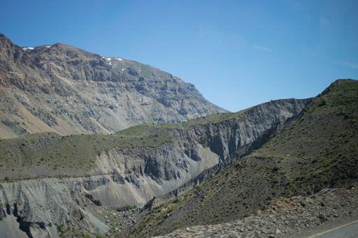 Panoramic view of a very arid mountainous area with dark gray material