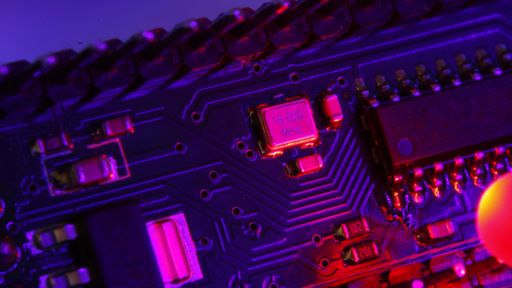 A closeup high angle shot of the lights and small pieces on an electronic board