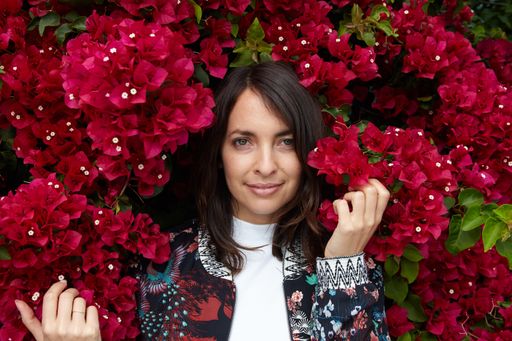 A female in the red flowers posing for the camera