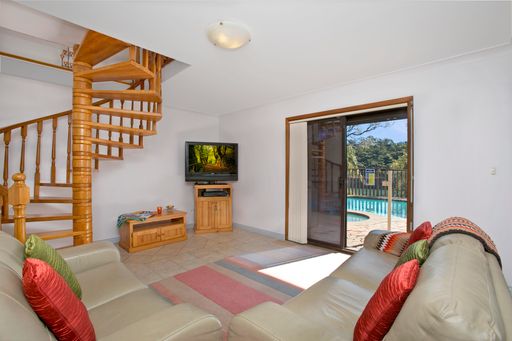 A living room interior with a view of the pool