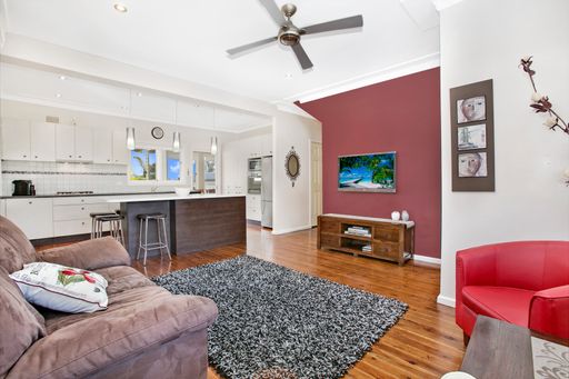 An interior view of a living room with a kitchen in a real estate in Sydney, Australia