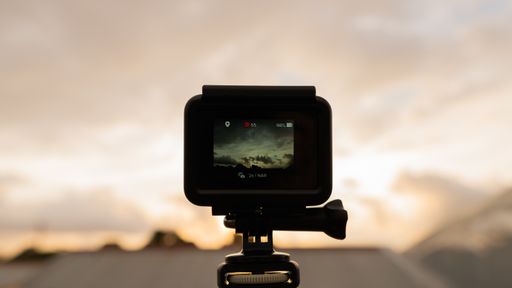 A selective focus shot of a camera capturing the beautiful clouds on a sunny day