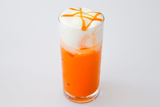 A serving of an orange cocktail with syrup