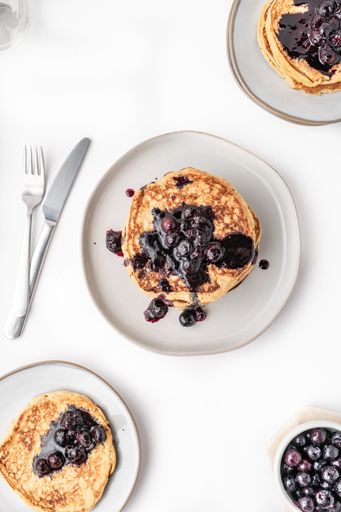 The fluffy blueberry pancakes for breakfast on the white table