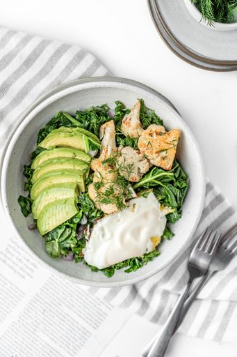 The top view of the fresh salad with a fried egg