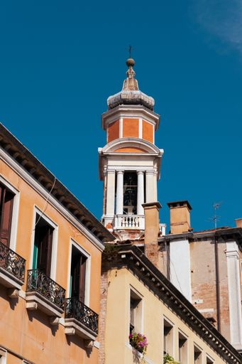 A vertical shot of the tower of a religious building in Venice, Italy