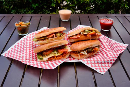 A Mexican tortas and souces on the table