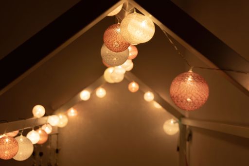 A closeup of a roof decorated with bright light garland