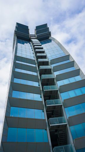 A vertical low angle shot of a beautiful skyscraper in Barcelona Spain