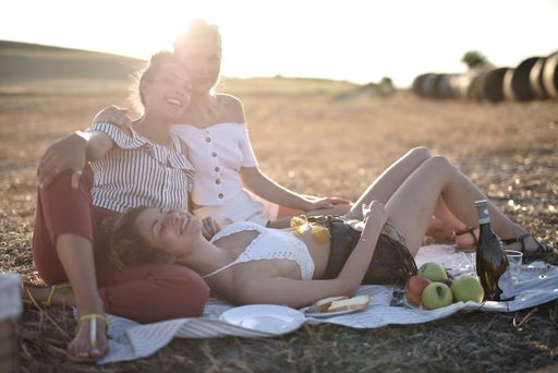 The sun shining over three female friends during a picnic